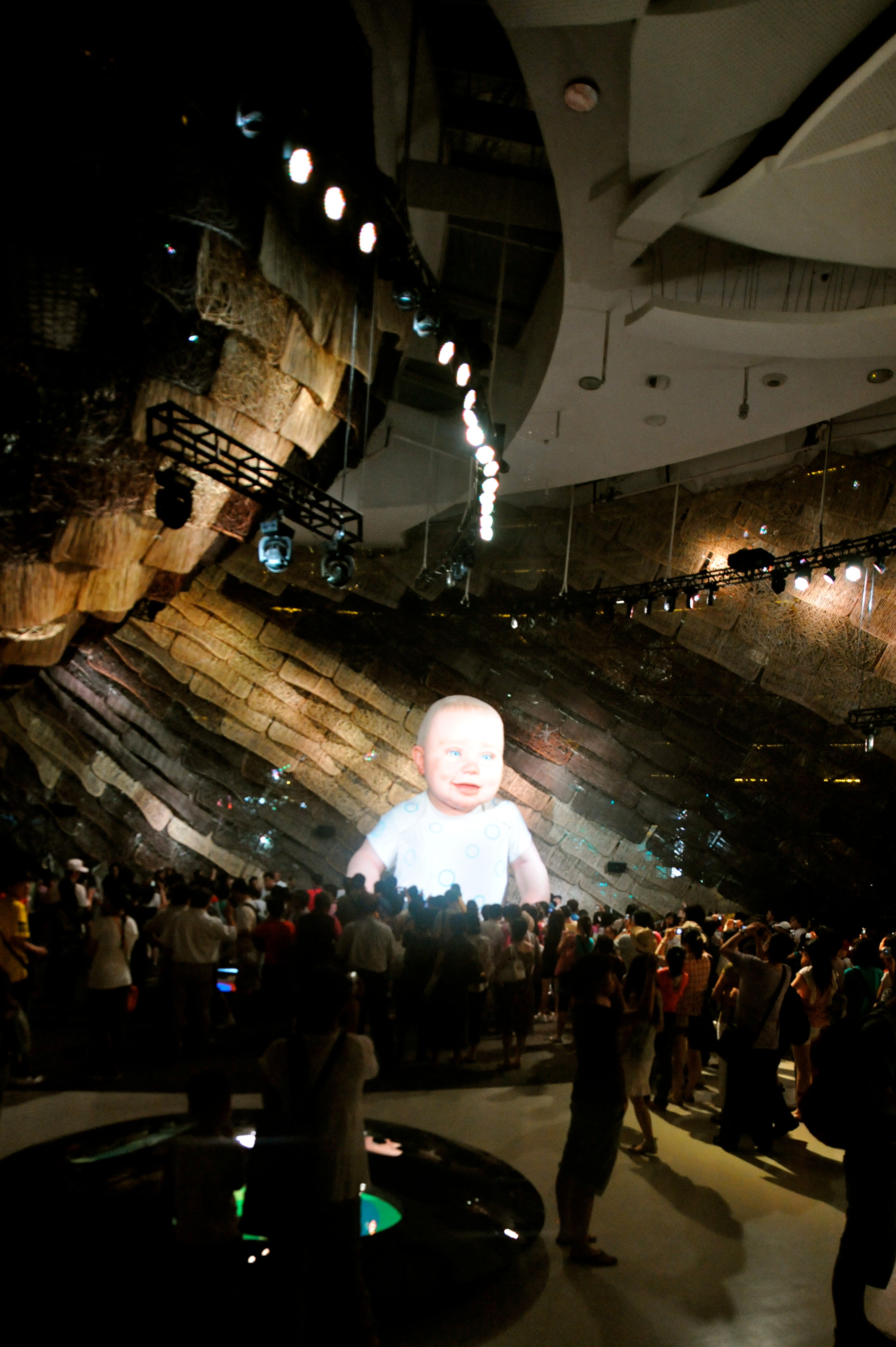 The interior has three major spaces, the most spectacular of which is dominated by one huge art piece.  A thirty foot tall animatronics baby looms over the crowded hall.