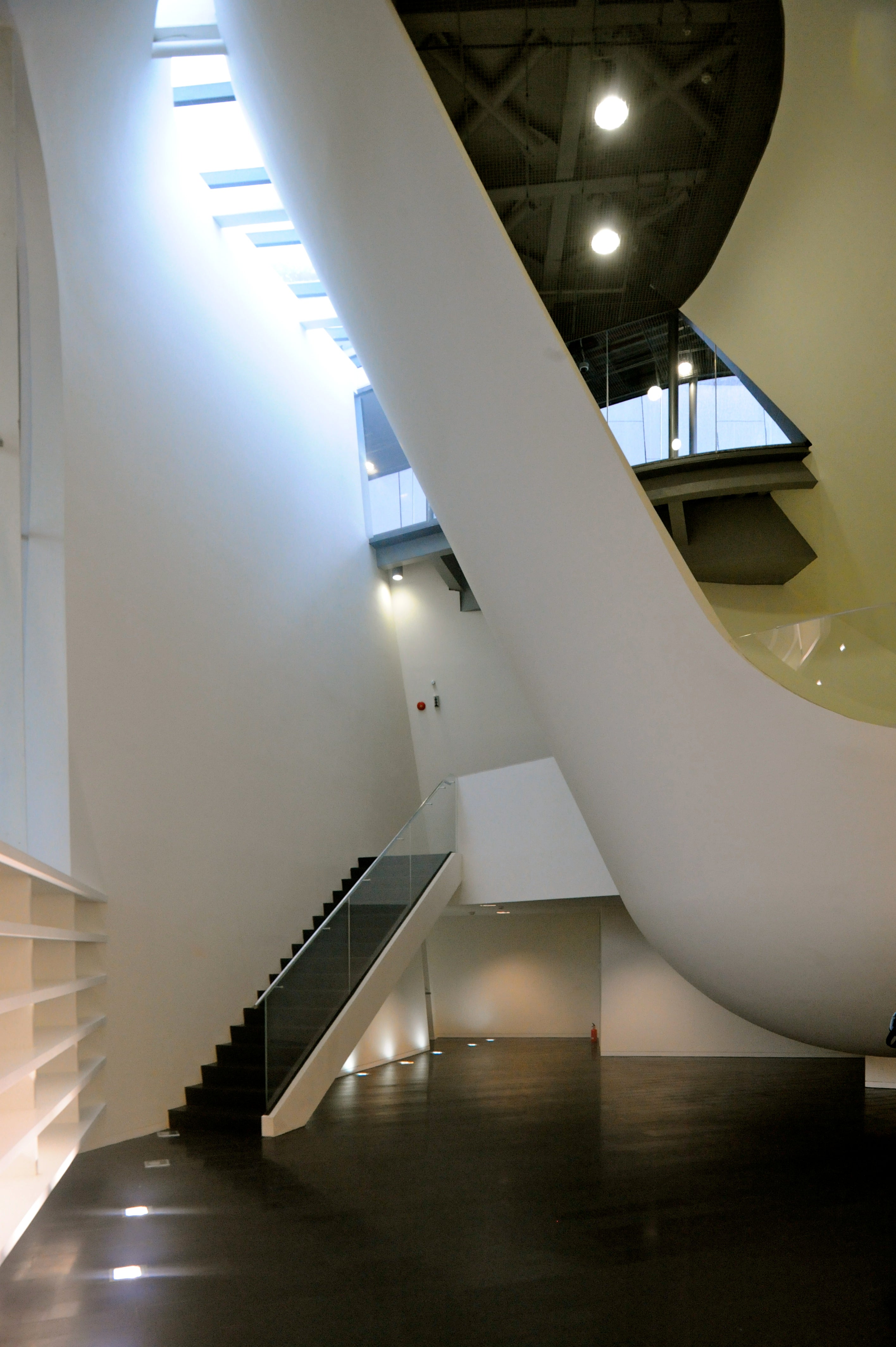 Library space is sculpted from white planes and volumes and is lit from all sides.