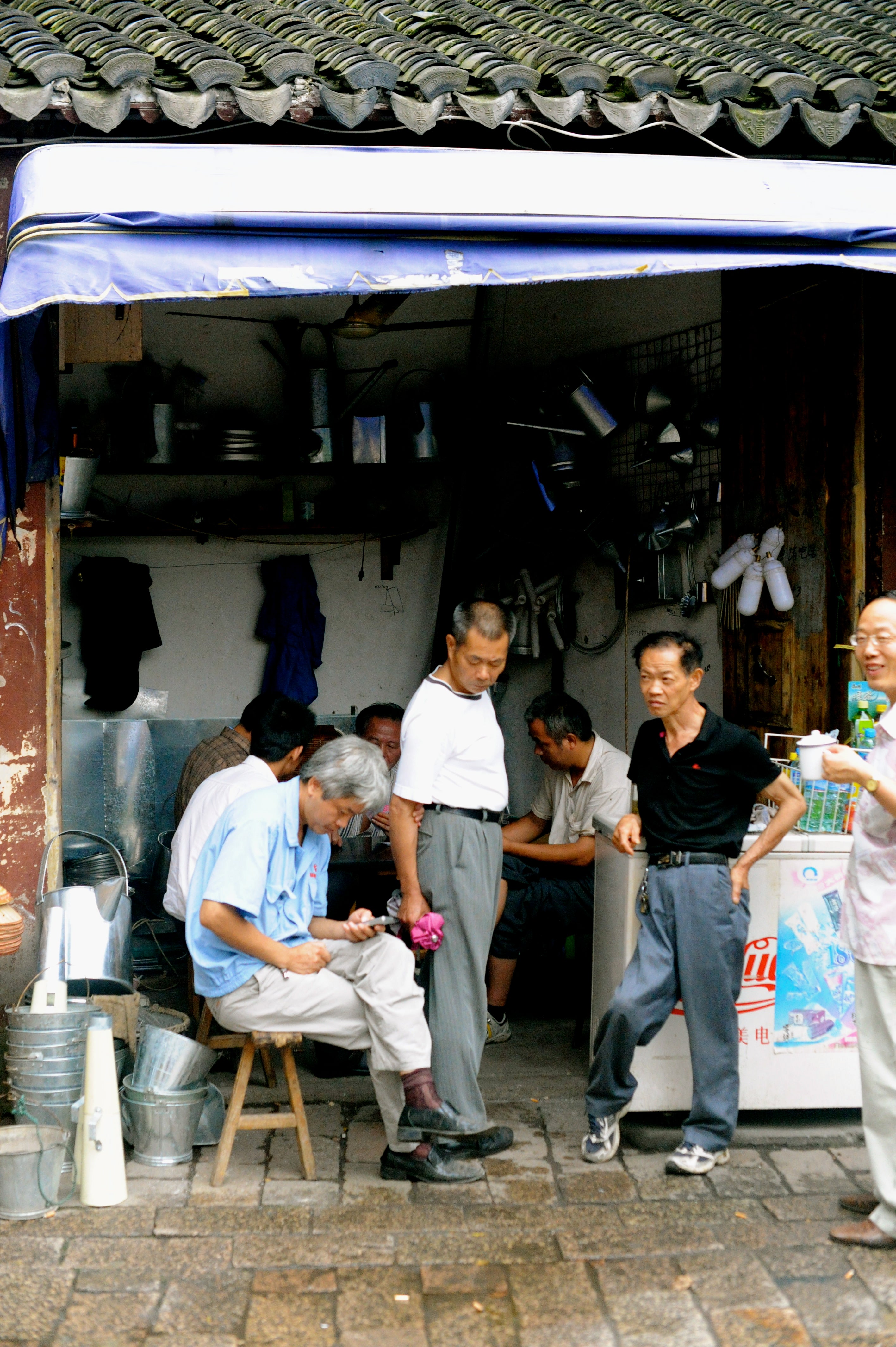 Guys just hanging out in a shop.