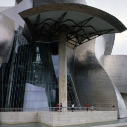 Guggenheim Art Museum in Bilbao Spain by Architect Frank Gehry photographed by Larry Speck on a cloudy day. Exterior titanium skin.