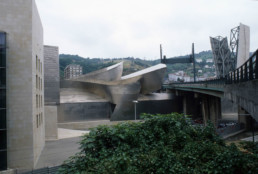 Guggenheim Art Museum in Bilbao Spain by Architect Frank Gehry, photographed by Larry Speck. Exterior, back, behind, limestone siding.