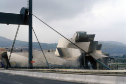 Guggenheim Art Museum in Bilbao Spain by Architect Frank Gehry, photographed by Larry Speck. View from La Salve Zubia bridge before renovation, no red arch yet.