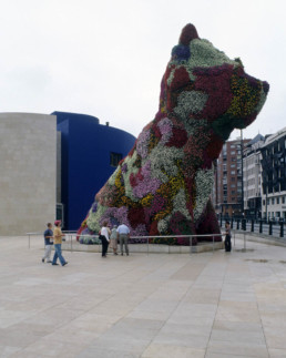 Guggenheim Art Museum in Bilbao Spain by Architect Frank Gehry, photographed by Larry Speck. Exterior, back, behind, limestone siding. Giant Flower Bear.