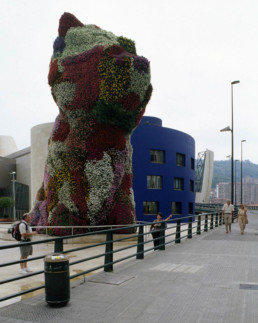 Guggenheim Art Museum in Bilbao Spain by Architect Frank Gehry, photographed by Larry Speck. Exterior, back, behind, limestone siding. Giant Flower Bear.